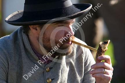 Civil War reenactor smoking a pipe made of antler in Pearland, Texas.