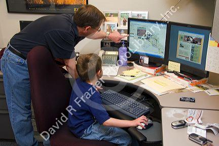 Father showing his son what he does at work for the Ada County Highway District on Take Our Daughters and Sons To Work Day in Boise, Idaho.