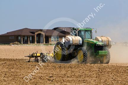 Tractor injecting herbicide into crop soil in Canyon County, Idaho.