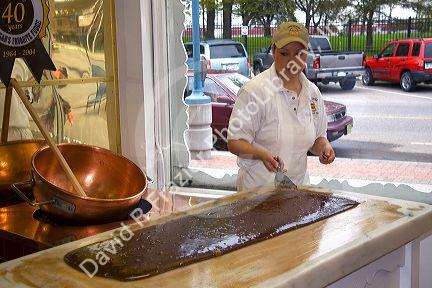 Worker making chocolate fudge at a candy shop in Sault Ste. Marie, Michigan.