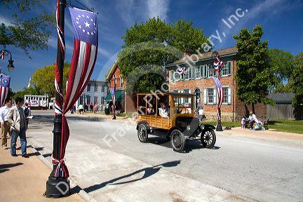Visitors ride in a Ford Woody on the streets of Greenfield Village at The Henry Ford in Dearborn, Michigan.