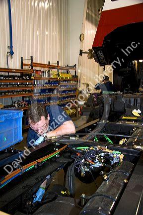 Worker manufacturing a truck chassis at Spartan Motors in Charlotte, Michigan.