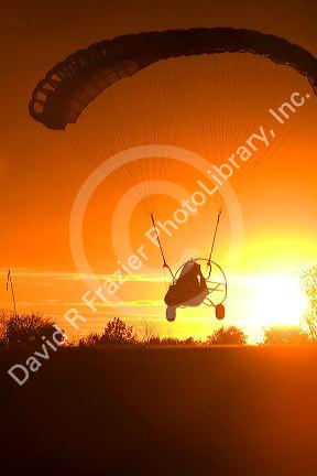 Powered parachute flying at sunset in Eation County, Michigan.