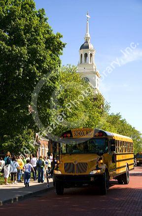 School bus parked in front of the Independence Hall replica at The Henry Ford Museum in Dearborn, Michigan.
