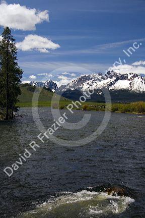 The Salmon River flowing through the Sawtooth Valley below the Sawtooth Mountain Range near Stanley, Idaho.