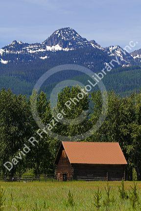 Log barn below the Mission Mountains north of Missoula, Montana.