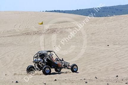 Dune buggy driving on sand dunes at St. Anthony, Idaho.
