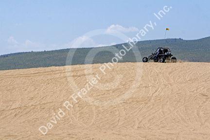 Dune buggy driving on sand dunes at St. Anthony, Idaho.