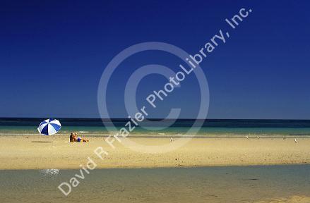 Beach scene with woman and umbrella near Adelaide, Australia. MR