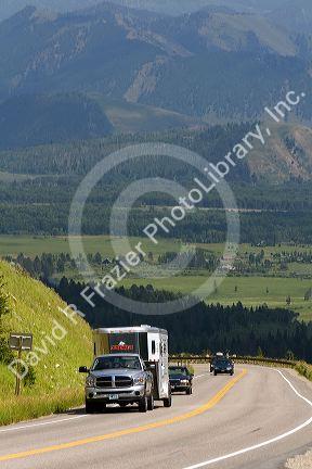 Vehicles travel over the high mountain Teton Pass on Wyoming Highway 22 near the state border of Wyoming and Idaho.