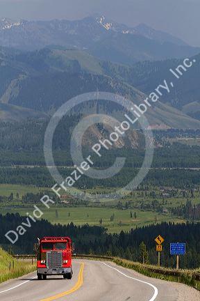 Dump truck traveling over the high mountain Teton Pass on Wyoming Highway 22 near the state border of Wyoming and Idaho.