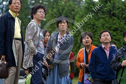 Asian tourists at Stanley Park in Vancouver, British Columbia, Canada.