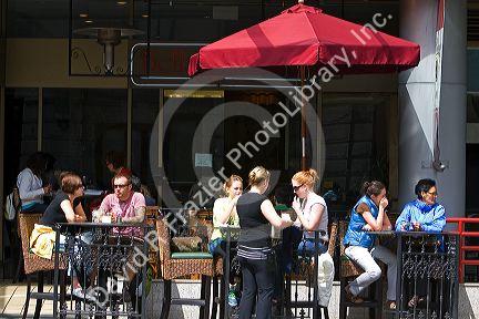 People dine at a sidewalk cafe in Vancouver, British Columbia, Canada.