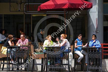 People dine at a sidewalk cafe in Vancouver, British Columbia, Canada.
