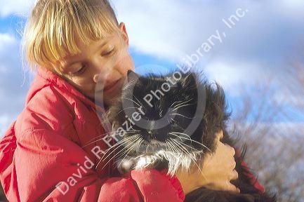 Young girl holding a cat.