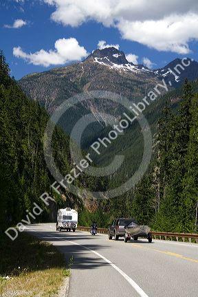 Camper, motorcylce and truck pulling a boat on Washington State Highway 20 in the North Cascade Range, Washington.