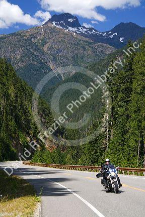 Motorcycle traveling on Washington State Highway 20 in the North Cascade Range, Washington.