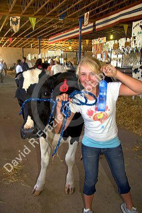 Girl showing her 4-H blue ribbon winning Holstein Cow at the Western Idaho Fair in Boise, Idaho. MR