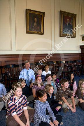 Governer John Lynch sitting with school children on a field trip to the New Hampshire State House at Concord, New Hampshire, USA.