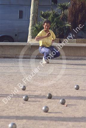 Man playing bocci ball in France.
