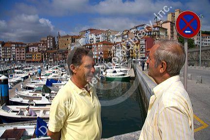 Basque men talk at the fishing port of Bermeo in the province of Biscay, Basque Country, Northern Spain.