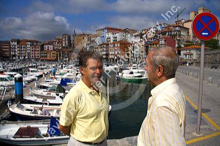 Basque men talk at the fishing port of Bermeo in the province of Biscay, Basque Country, Northern Spain.