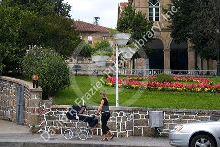 Woman pushing a baby carriage in the town of Guernica in the province of Biscay, Basque Country, Northern Spain.