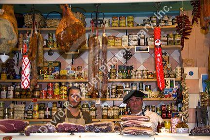 French Basque men working in a shop selling cheese and meats in the town of Saint-Jean-de-Luz, Pyrenees Atlantiques, French Basque Country, Southwest Spain.