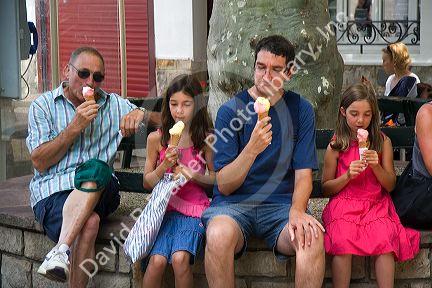 Family eating ice cream in the town of Saint-Jean-de-Luz, Pyrenees-Atlantiques, French Basque Country, Southwest France.