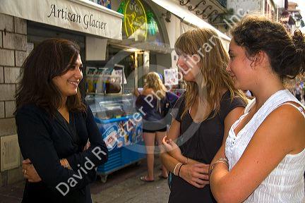 Young women socialize in the town of Saint-Jean-de-Luz, Pyrenees-Atlantiques, French Basque Country, Southwest France.