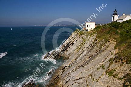 Coastal cliffs and lighthouse above the bay at Saint-Jean-de-Luz, Pyrenees Atlantiques, French Basque Country, Southwest France.
