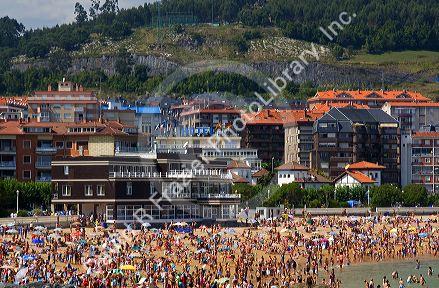 Crowded beach scene at Castro Urdiales, Cantabria, northern Spain.