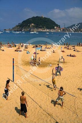 Beach volleyball being played at La Concha Bay in the city of Donostia-San Sebastian, Guipuzcoa, Basque Country, Northern Spain.