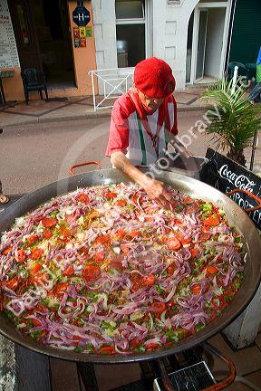 French Basque man cooking paella in the town of Biarritz, Pyrenees-Atlantiques, French Basque Country, Southwest France.