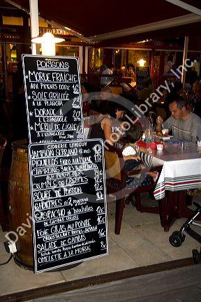 People dine outdoors at a restaurant in Saint-Jean-de-Luz, Pyrenees Atlantiques, French Basque Country, Southwest France.