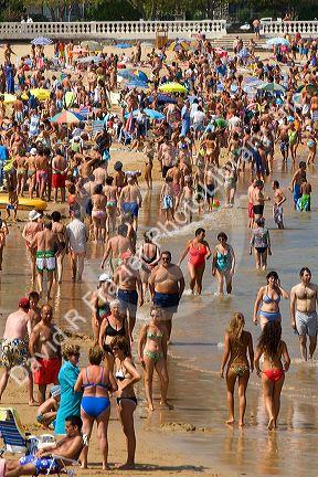 Crowded beach scene at Castro Urdiales, Cantabria, northern Spain.
