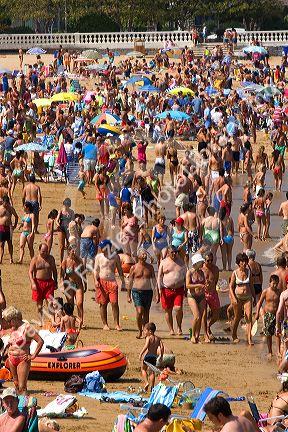 Crowded beach scene at Castro Urdiales, Cantabria, northern Spain.