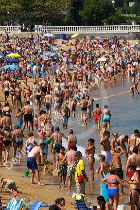 Crowded beach scene at Castro Urdiales, Cantabria, northern Spain.