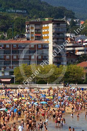 Crowded beach scene at Castro Urdiales, Cantabria, northern Spain.