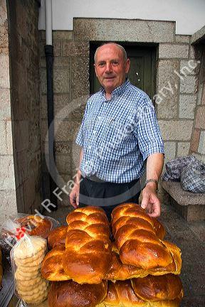 Vendor selling bread at an outdoor market in the town of Cangas de Onis, Asturias, northern Spain.