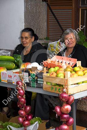 Women selling produce and eggs at an outdoor market in the town of Cangas de Onis, Asturias, northern Spain.