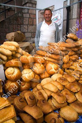 Vendor selling bread and baked goods at an outdoor market in the town of Cangas de Onis, Asturias, northern Spain.