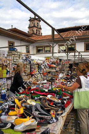 Vendor selling shoes at an outdoor market in the town of Cangas de Onis, Asturias, northern Spain.