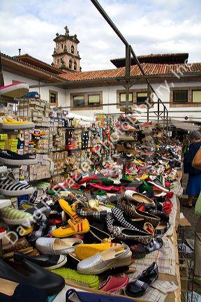 Vendor selling shoes at an outdoor market in the town of Cangas de Onis, Asturias, northern Spain.