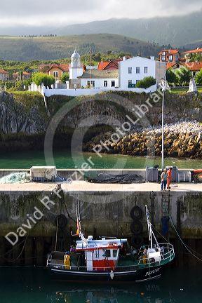 Fishing boat in the harbor at Llanes, Asturias, Spain.