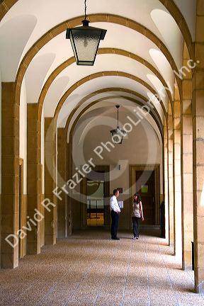People talk under an arched portico on the campus of the University of Deusto in the city of Bilbao, Biscay, northern Spain.