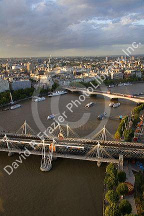 The Hungerford Bridge, Golden Jubilee Bridge, and the Waterloo Bridge crossing the River Thames in the city of London, England.