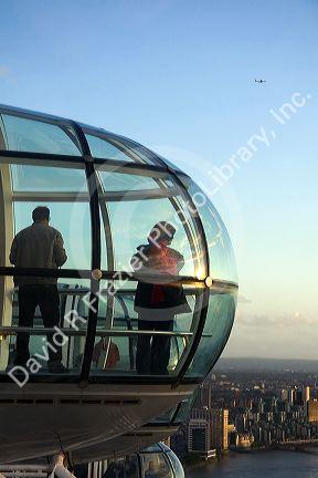 Tourists view the city of London from the London Eye, England.