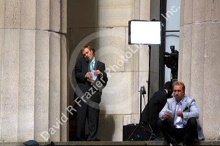 News reporters on the steps of Federal Hall located at 26 Wall Street in New York City, New York, USA.