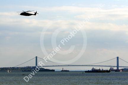 Navy helicopter flying near the Verrazano-Narrows Bridge in New York Harbor, New York, USA.